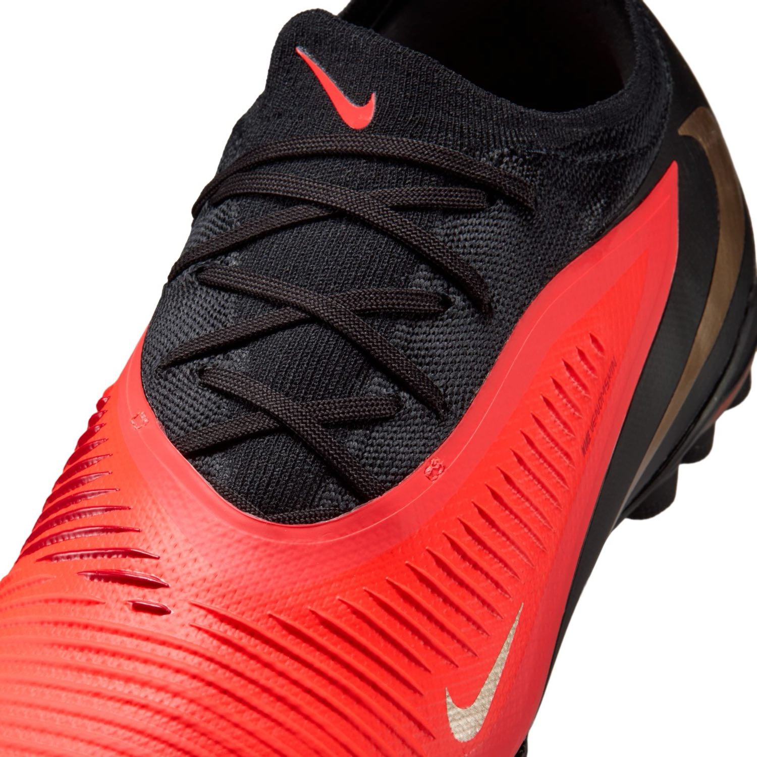 Nike Phantom 6 Low Pro TF red and black turf soccer shoes with VNMSkin upper and rubber outsole.