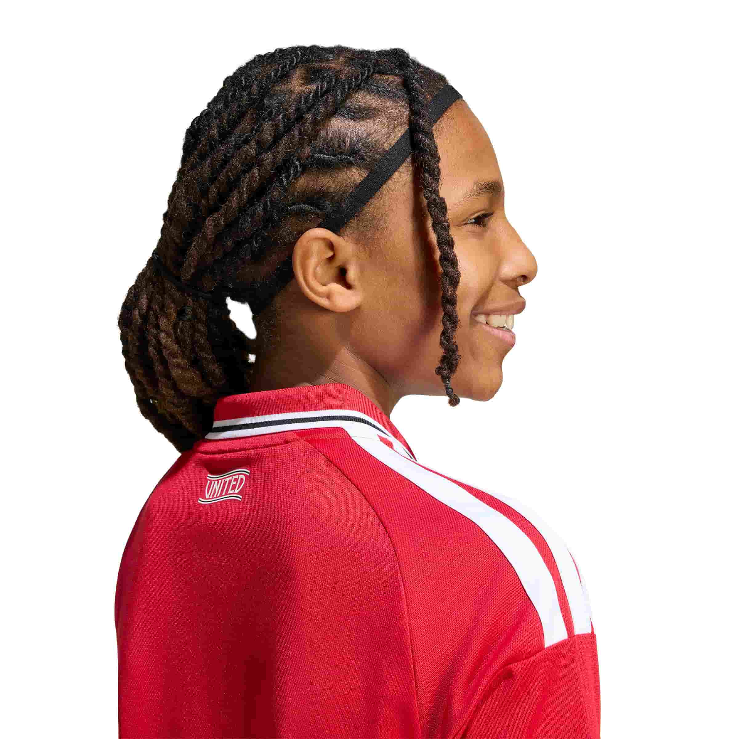 Kid wearing Manchester United 26/27 Home Jersey Youth side view