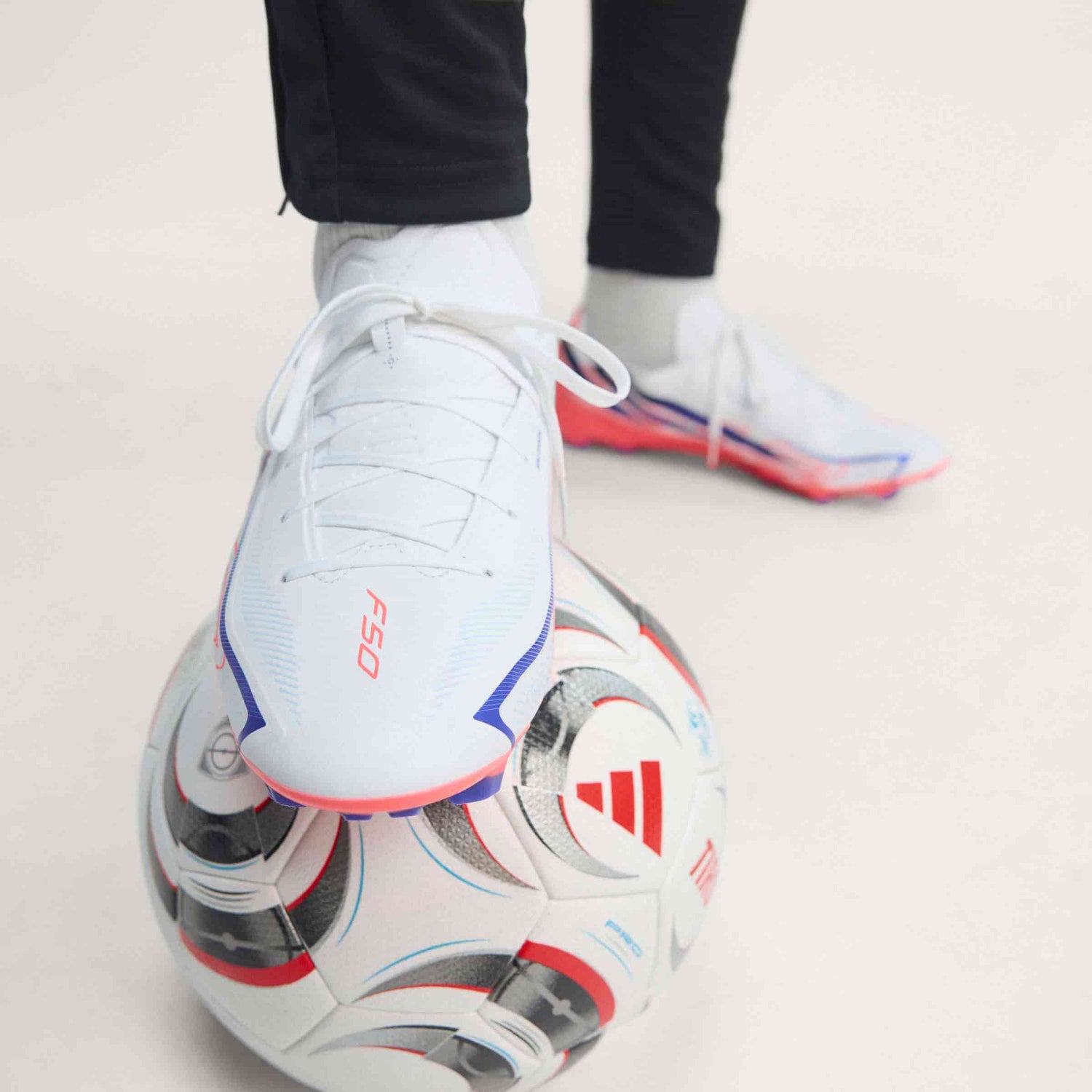 adidas F50 Hyperfast League FG soccer cleats in white, pink and navy with firm-ground outsole